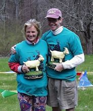 the winners, wearing blue goat shirts and holding yellow goat trophies
